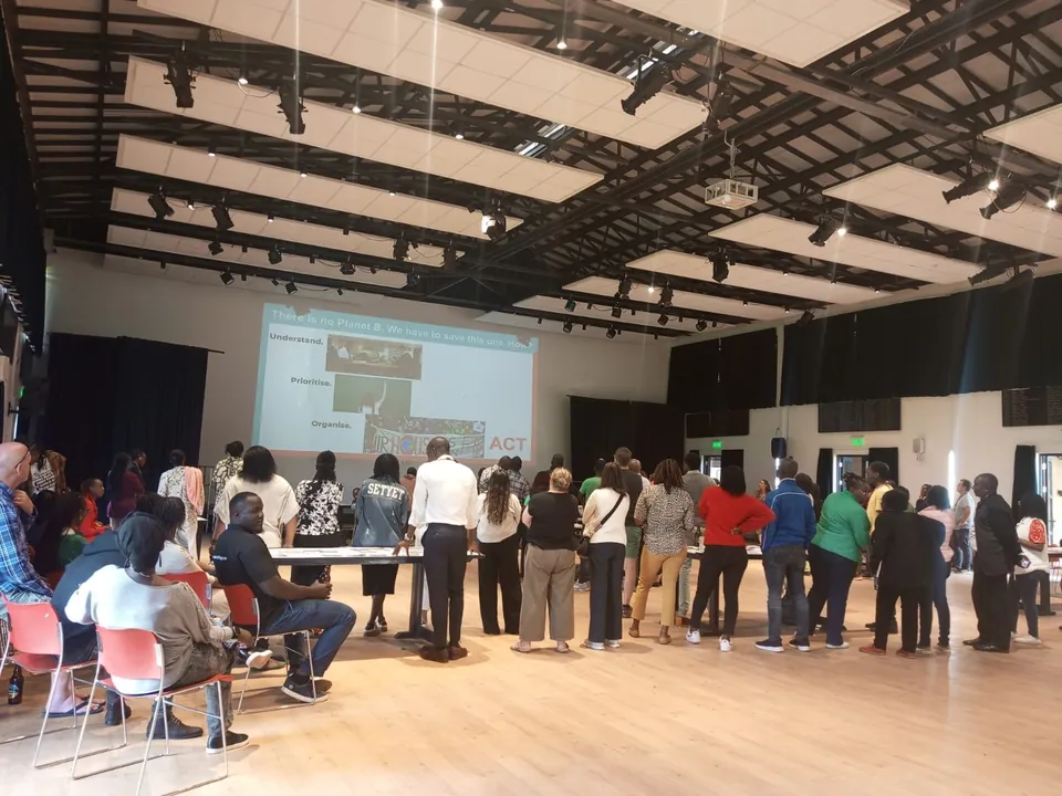Delegates at a Climate Fresk workshop watching a presentation on climate actions
