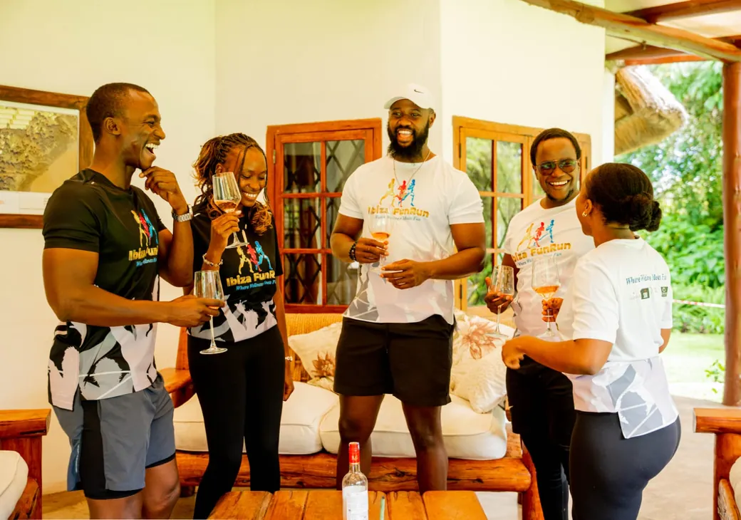 Event participants in branded shirts celebrating together after a fitness event