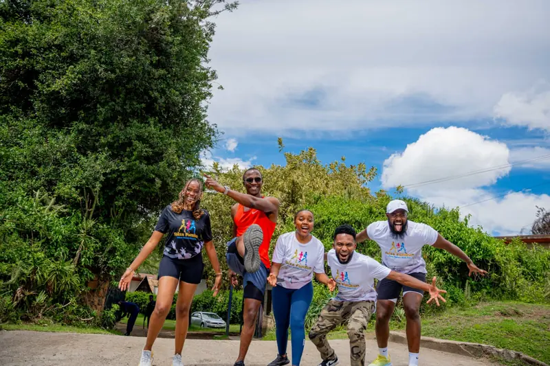 The events team in matching shirts doing a jumping pose at a fitness event