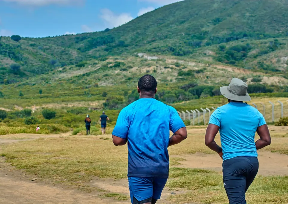 A group heading out together toward green hills during a community outdoor event