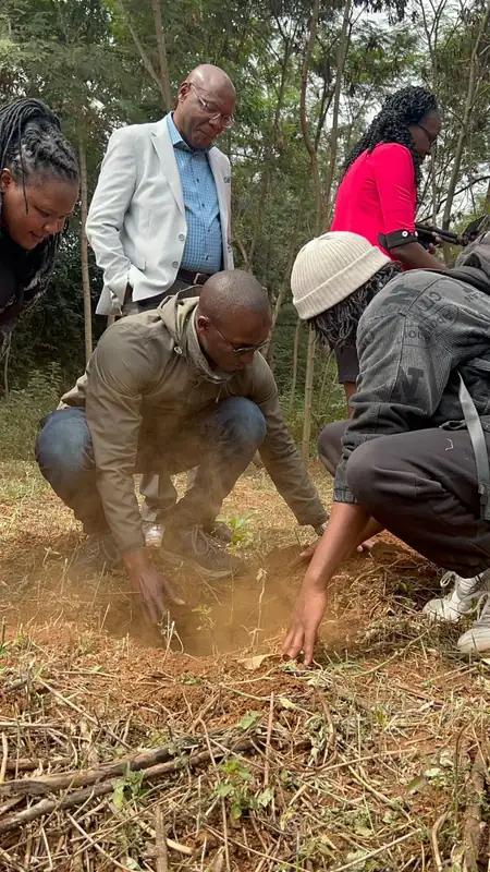 Community members planting a seedling during a corporate tree-planting day in Naivasha