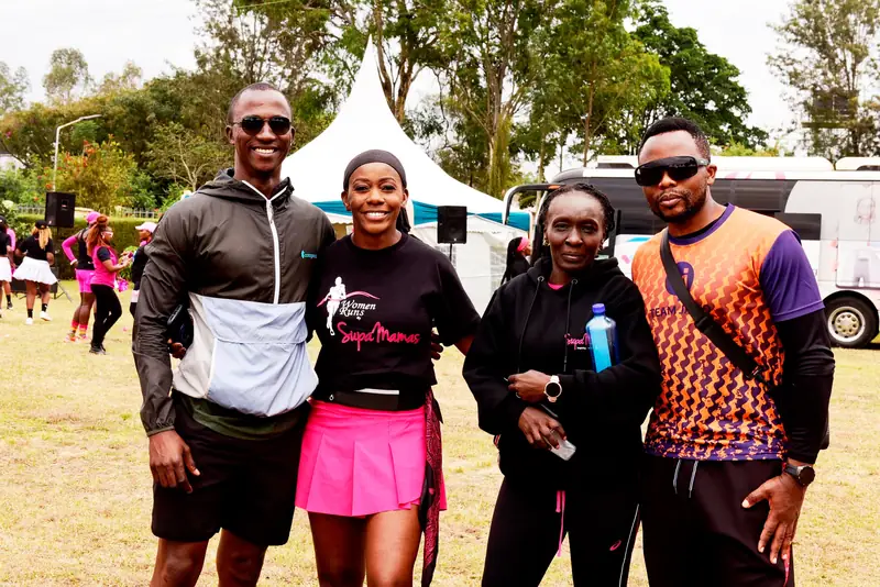 A group in branded Women Runs Supa Mamas shirts at a fitness event